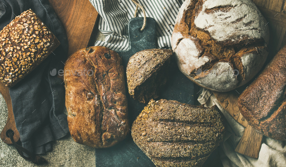 Flat-lay of various bread loaves, top view, wide composition - Stock Photo - Images
