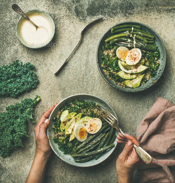 Quinoa, kale, beans, avocado, egg with creamy tahini dressing bowls - Stock Photo - Images