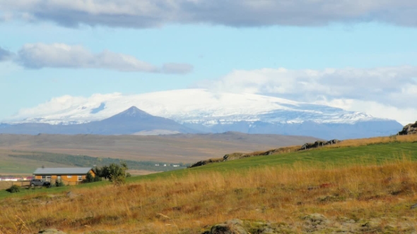 Huge Snow-capped Top of Glacier in Iceland, View From Far Through Fall Fields in Sunny Day