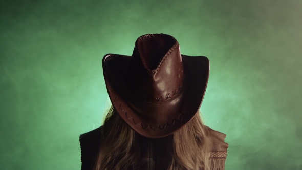 Cowboy Girl Raises Her Head and Looks Into the Distance. Smoke Background alt