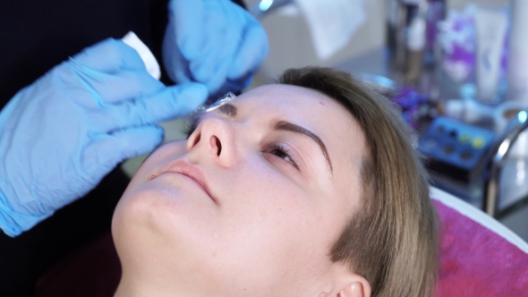 Beautician, Specialist of Permanent Make-up Is Wipes Out the Remains of Local Anesthesia Before the