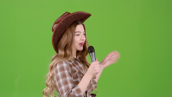 Girl Sings Into a Retro Country Music Microphone. Green Screen. Side View alt