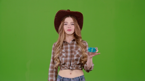 Cowboy Girl in a Hat Shows a Okey. Green Screen alt