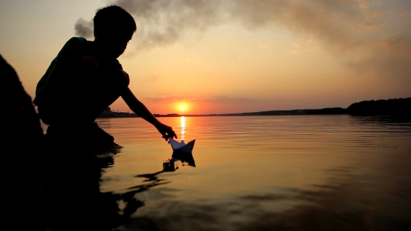 Boy Playing With Paper Boat alt