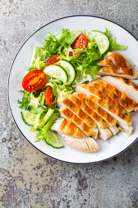 Chicken breast or fillet, poultry meat grilled and fresh vegetable salad of tomato Stock Photo by sea_wave