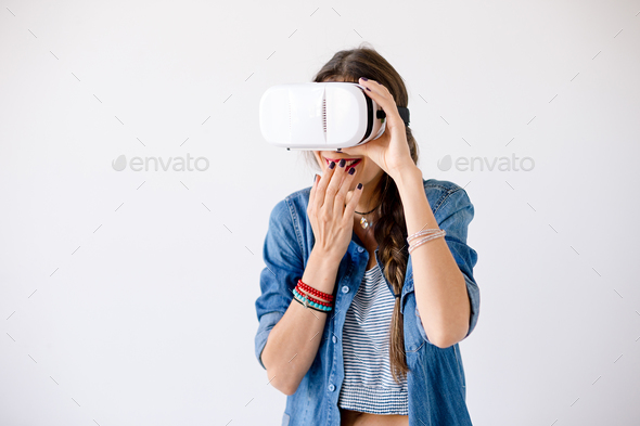 Girl portrait giggling while using VR Glasses - Stock Photo - Images