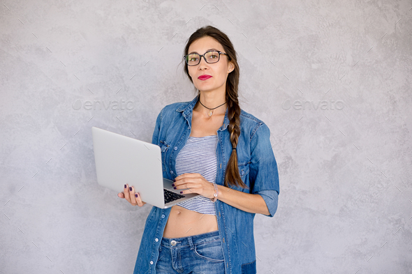 Beautiful girl with laptop in studio - Stock Photo - Images