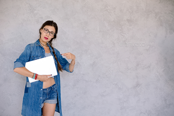 Young woman pointing with finger on notebook - Stock Photo - Images