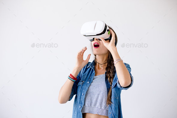 Excited girl with VR glasses in studio - Stock Photo - Images