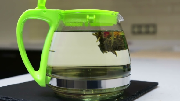 Brewing Flower Tea in the Kitchen in a Glass Teapot