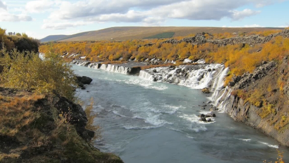 Valley with Famous and Picturesque Waterfalls Hraunfossar in Iceland in Sunny Autumn Weather