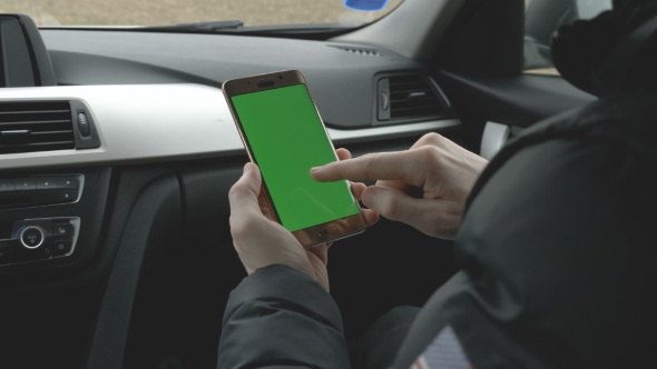 GREEN SCREEN Man Holding His Smartphone in a Car