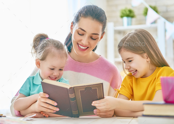 Mom and children reading a book Stock Photo by choreograph | PhotoDune