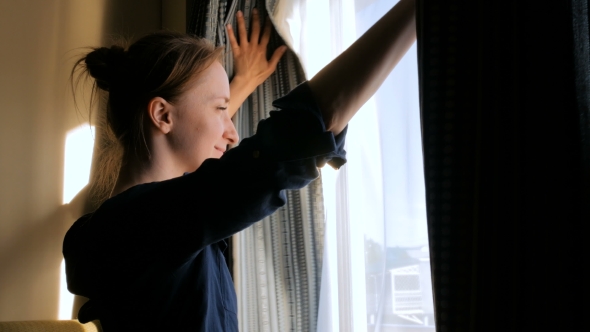 Woman Opening Window Curtains