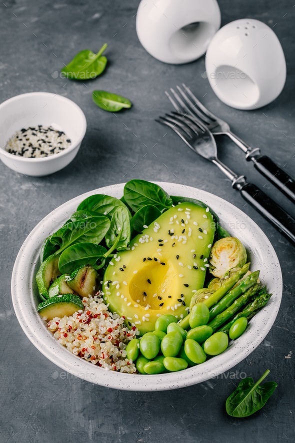 vegetarian bowl salad with quinoa, spinach, avocado, brussels sprouts, zucchini, asparagus, edamame - Stock Photo - Images
