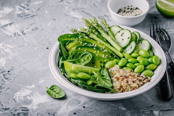 Green bowl salad with fresh vegetables and quinoa, spinach, avocado, asparagus, cucumber, edamame - Stock Photo - Images