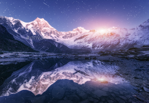 Himalayn mountains and mountain lake at starry night in Nepal Stock Photo by den-belitsky