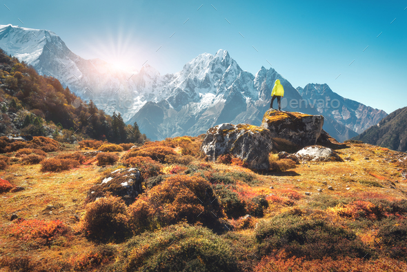Man on the stone and mountains at sunset in Nepal - Stock Photo - Images