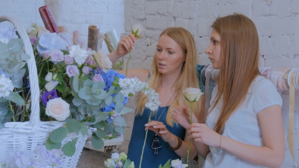 Two Women Florists Making Large Floral Basket with Flowers at Flower Shop