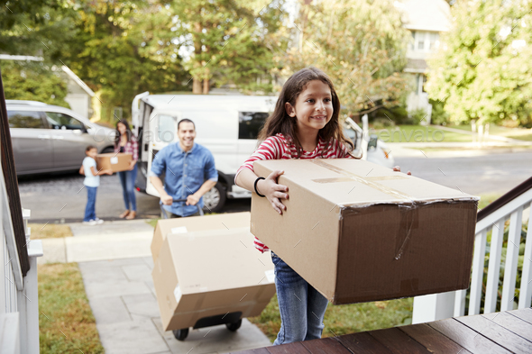 Children Helping Unload Boxes From Van On Family Moving In Day Stock Photo by monkeybusiness