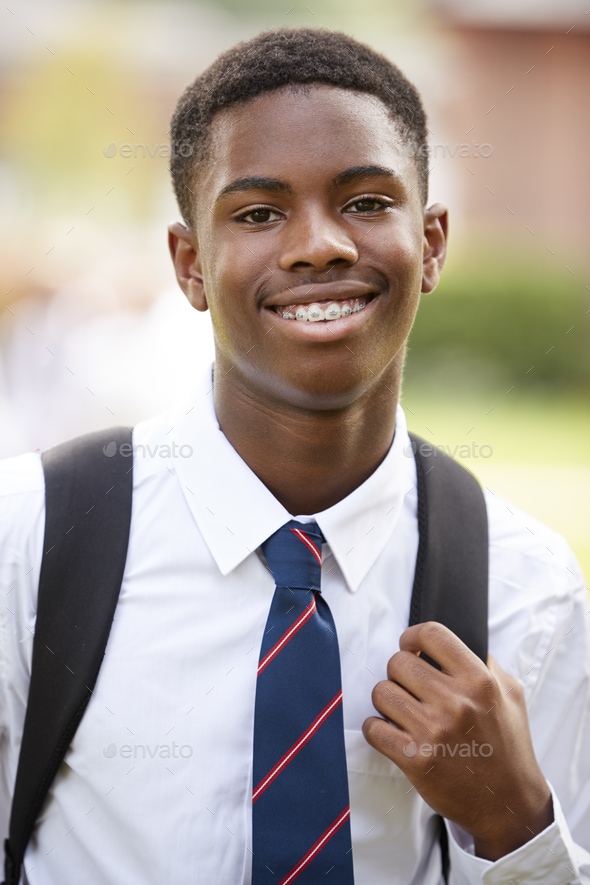 Portrait Of Male Teenage Student In Uniform Outside Buildings Stock Photo by monkeybusiness