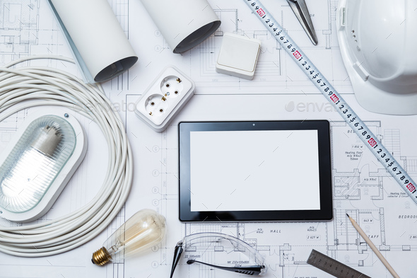 Construction drawing with tools and tablet with blank screen Stock Photo by Vladdeep