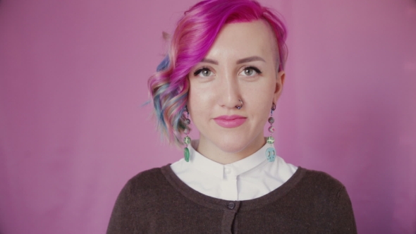 Portrait of Happy Young Girl with Multi-colored Hair Chooses Between Looking Surprised