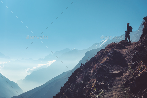 Woman on the hill and mountains at bright day - Stock Photo - Images
