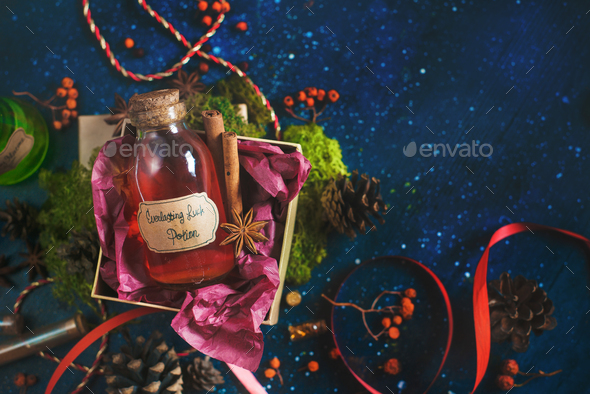 Present box with a bottle of Luck Potion. Magical still life with potion bottles, ingredients and