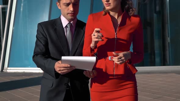 Young, Beautiful Businesswoman Signing Businessman Documents alt