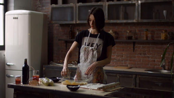 Pretty Young Woman Putting Baking Pan Into Oven alt