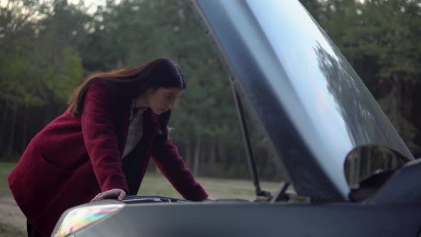 Disappointed Woman Looking at Open Hood Breakdown Car on Road Car Accident