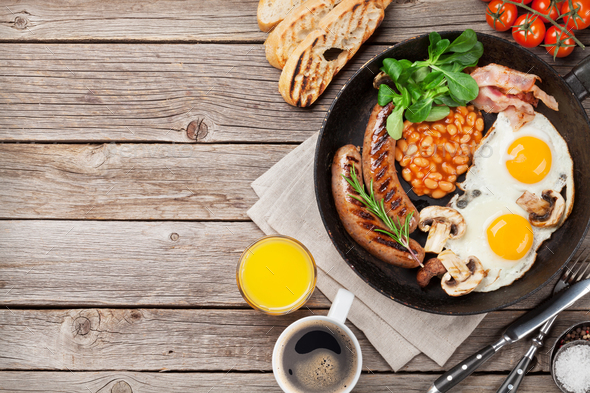 English breakfast. Fried eggs, sausages, bacon - Stock Photo - Images