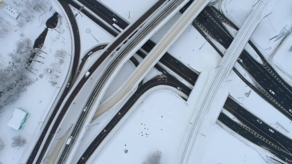 Aerial View of a Freeway Intersection Snow-covered in Winter. alt