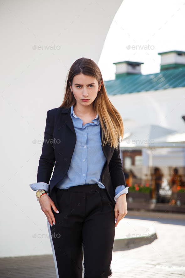 Fashionable women\'s look with black jacket and blue blouse. - Stock Photo - Images