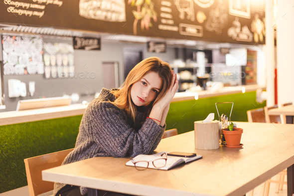 Young woman freelancer sitting in cafe after hard work day - Stock Photo - Images