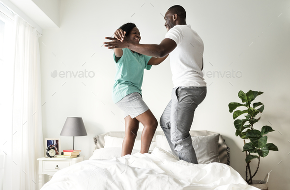 Black couple jumping on bed together Stock Photo by Rawpixel | PhotoDune