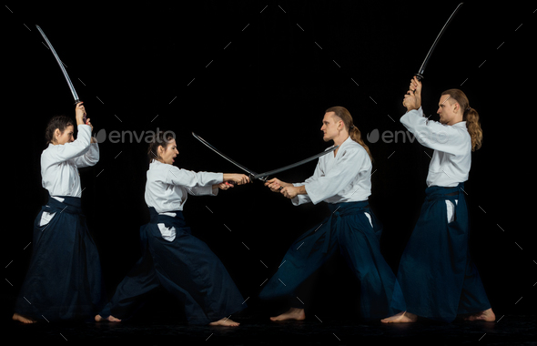 Man and woman fighting at Aikido training in martial arts school - Stock Photo - Images
