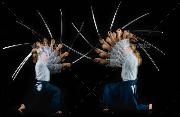 Man and woman fighting at Aikido training in martial arts school - Stock Photo - Images