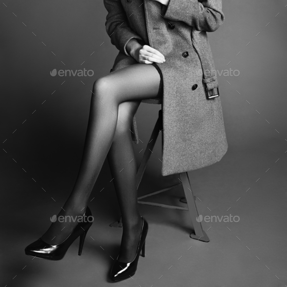 Young woman in coat with beautiful feet - Stock Photo - Images