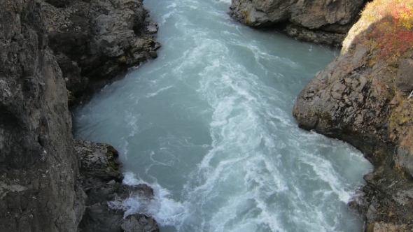 Rapid Mountain River Flow Between Hard Black Rocks, Dramatic Shot