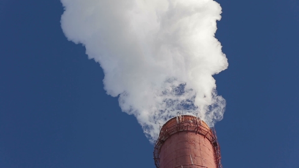 White Beautiful Smoke from a Chimney on a Blue Sky. alt