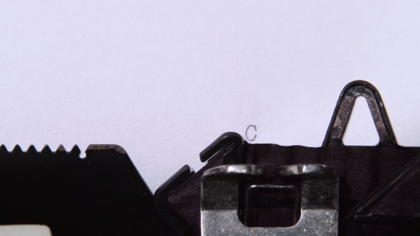 Journalist Prints the Word Confidential on the Retro Typewriter. alt