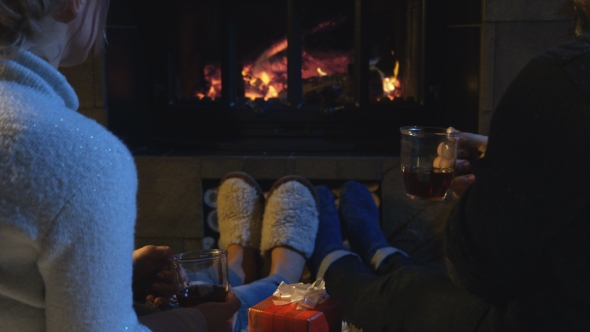 Romantic Couple Relaxing in Front of a Fire alt