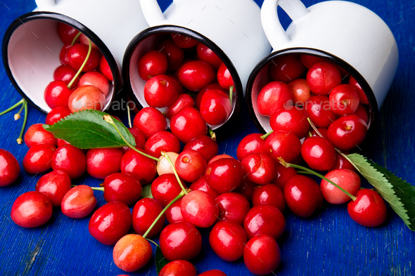 Cherry in enamel cup - Stock Photo - Images