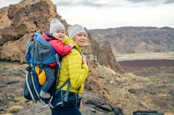 Family hike, mother with baby in backpack Stock Photo by blas | PhotoDune
