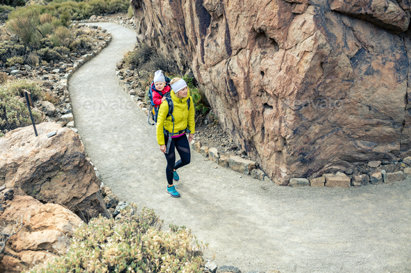 Super mom with baby boy hiking in backpack - Stock Photo - Images