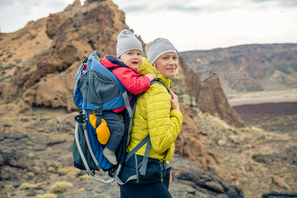 Family hike, mother with baby in backpack Stock Photo by blas | PhotoDune