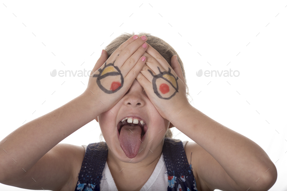 Little girl with eyes drawn on her hands making a goofy face