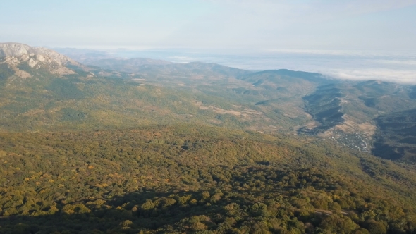 Aerial Shot of Beautiful Mountains Covered By Autumn Forest. Flight Above Mountains on Sunset alt